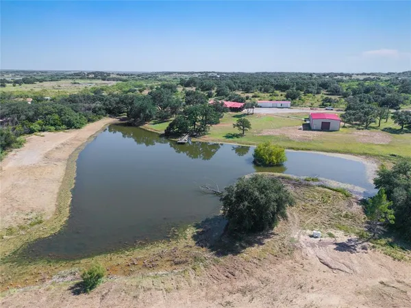 a view of a lake with houses in the background