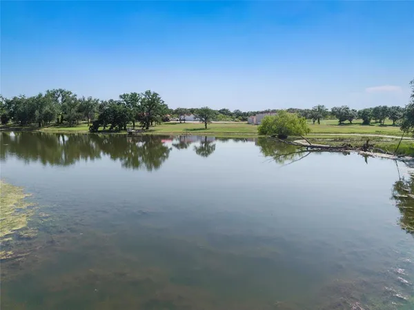 a view of a lake with couches chairs