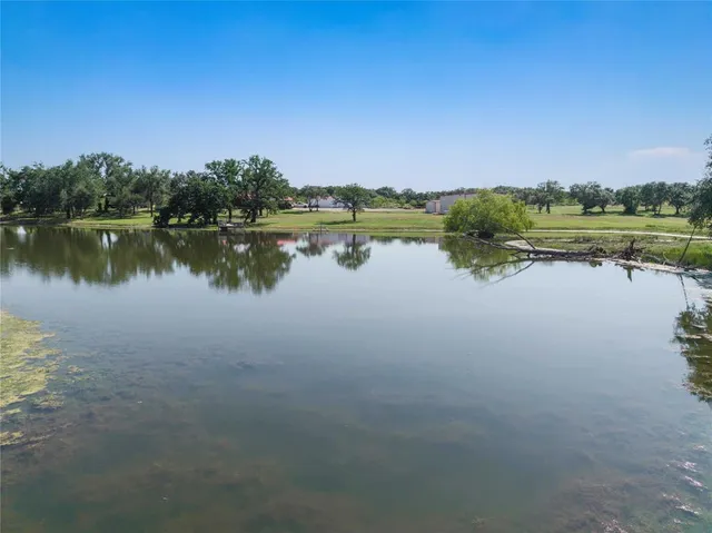 a view of a lake with couches chairs
