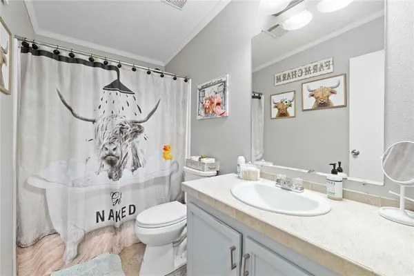 a bedroom with furniture and a wooden floor