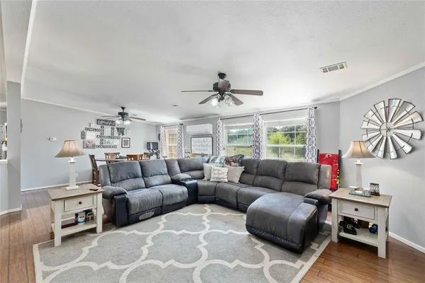 a living room with furniture ceiling fan and a rug
