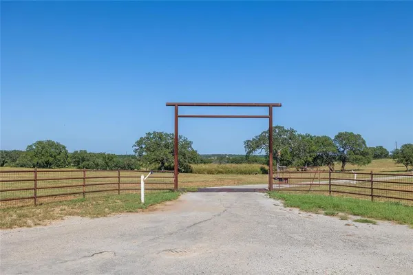 a view of a wooden fence and trees