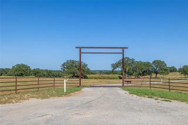 a view of a wooden fence and trees