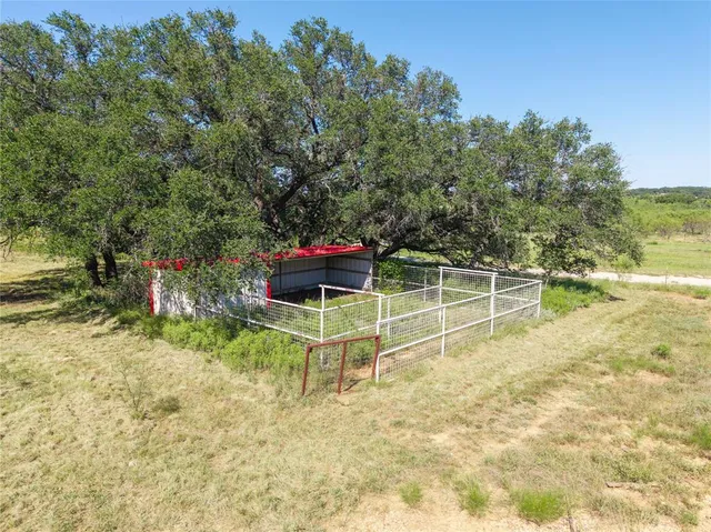 an aerial view of ocean and residential houses with outdoor space