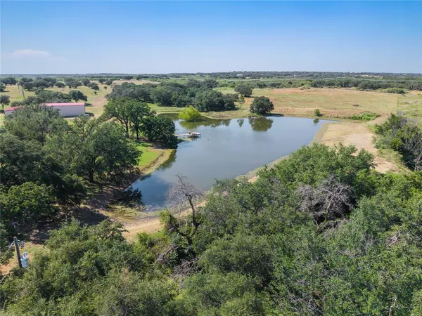 an aerial view of a houses with a lake view