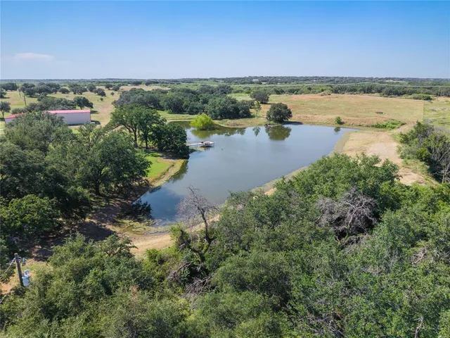 an aerial view of a houses with a lake view