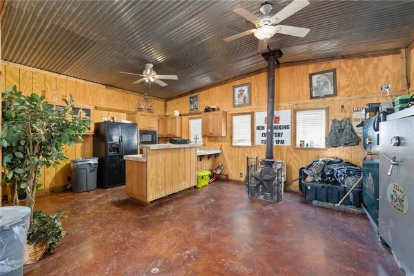 a kitchen that has a refrigerator a stove and a sink with wooden floor