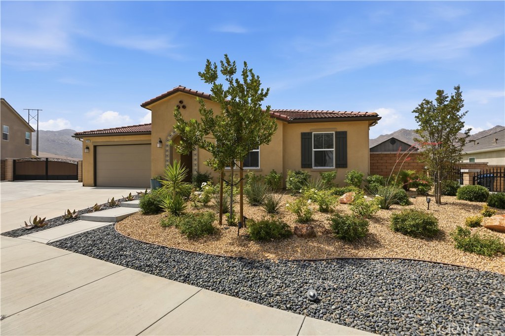 21159 Blue Jeans Court Riverside, CA 92507 - Photo 7 of 63 a front view of a house with garden