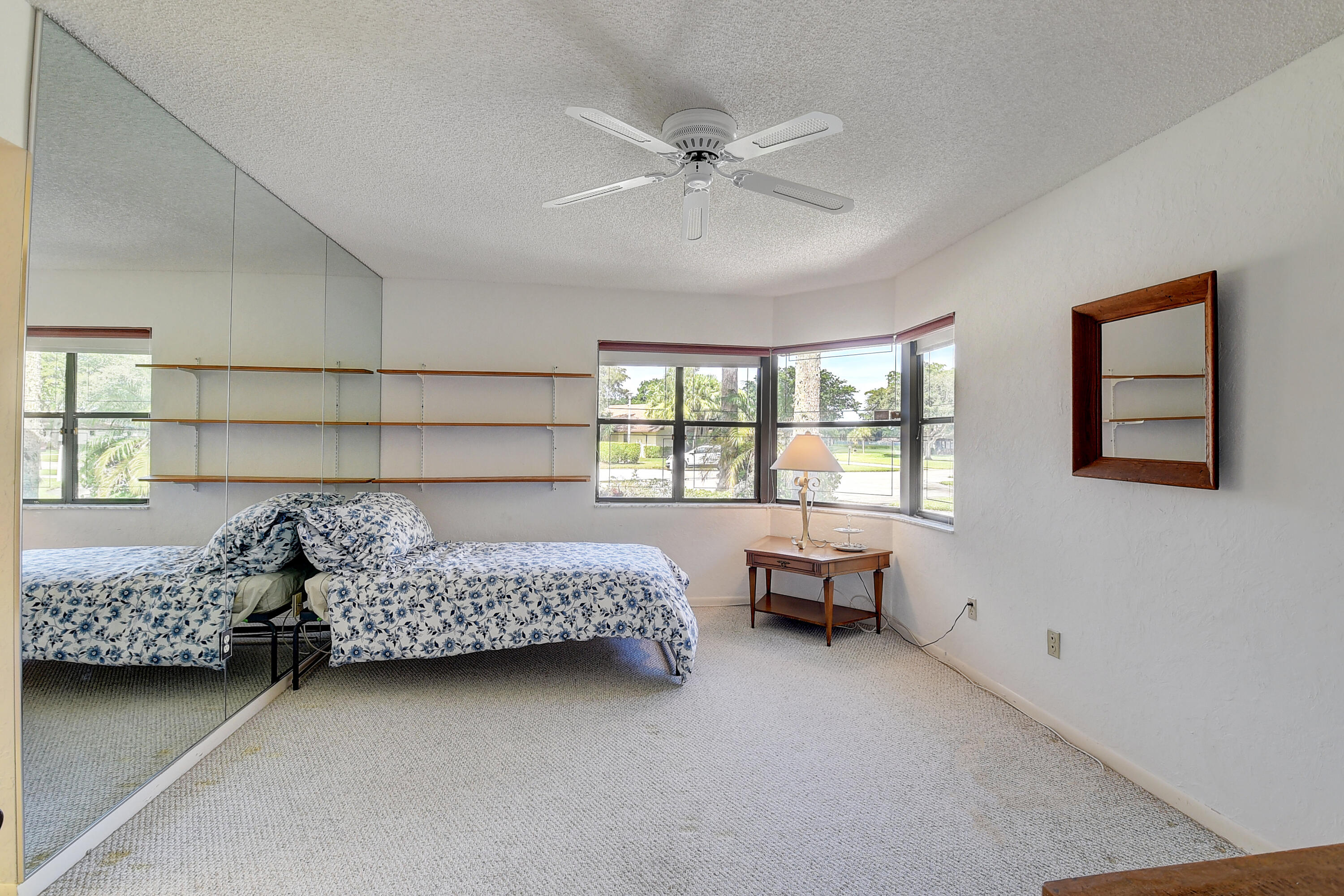 5642 Forest Oaks Terrace Delray Beach, FL 33484 - Photo 13 of 37 a bed room with a bed and furniture