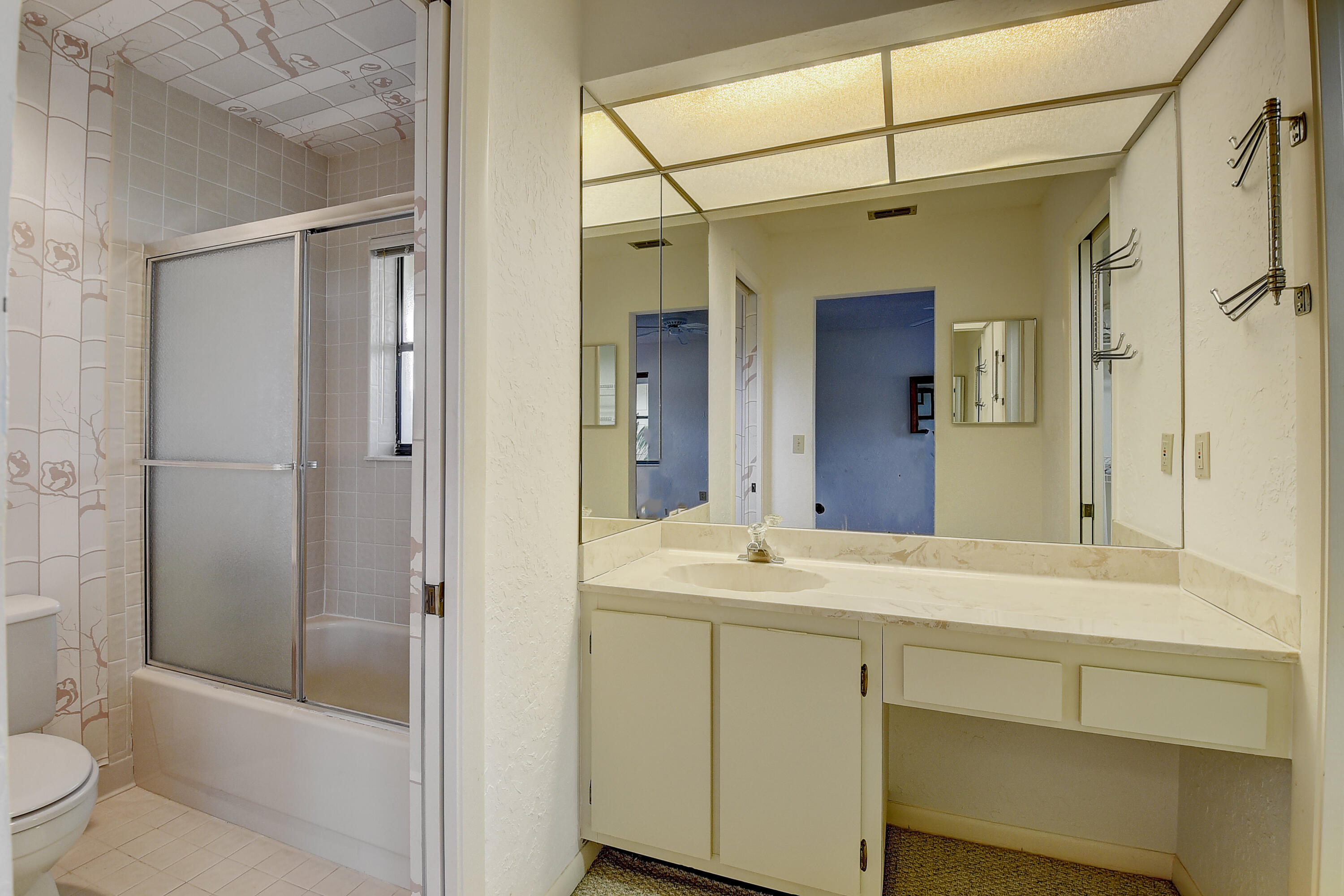 5642 Forest Oaks Terrace Delray Beach, FL 33484 - Photo 14 of 37 a bathroom with a sink a toilet and shower