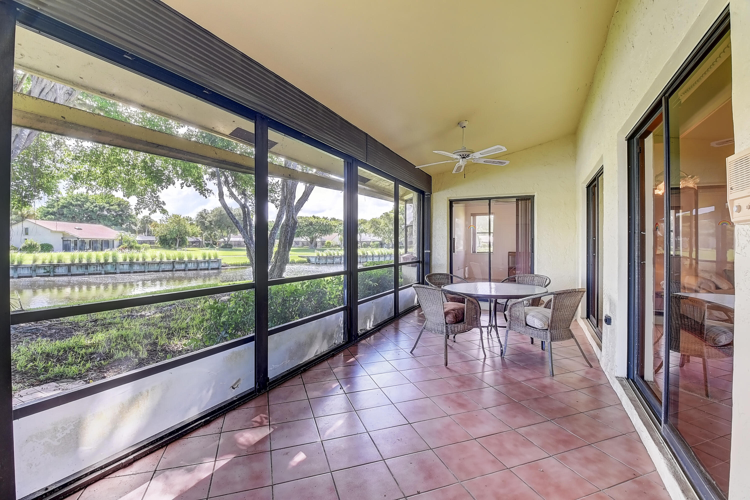 5642 Forest Oaks Terrace Delray Beach, FL 33484 - Photo 15 of 37 a dining room with furniture and a floor to ceiling window