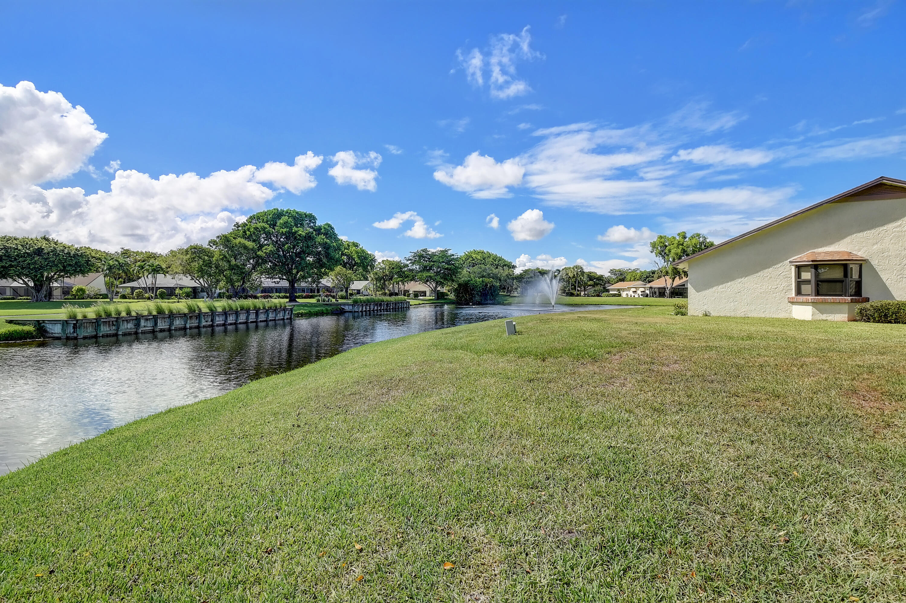 5642 Forest Oaks Terrace Delray Beach, FL 33484 - Photo 21 of 37 a view of a lake with houses in the background