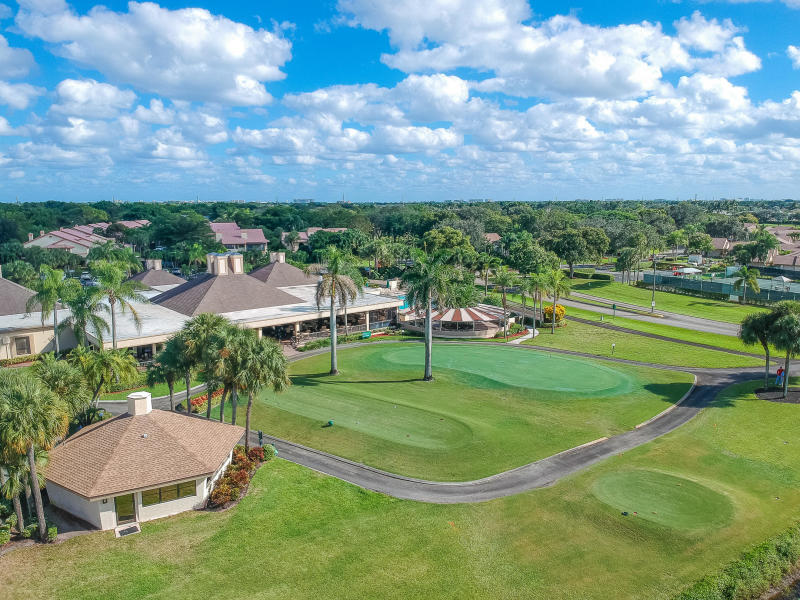5642 Forest Oaks Terrace Delray Beach, FL 33484 - Photo 27 of 37 a view of a big yard with table and chairs