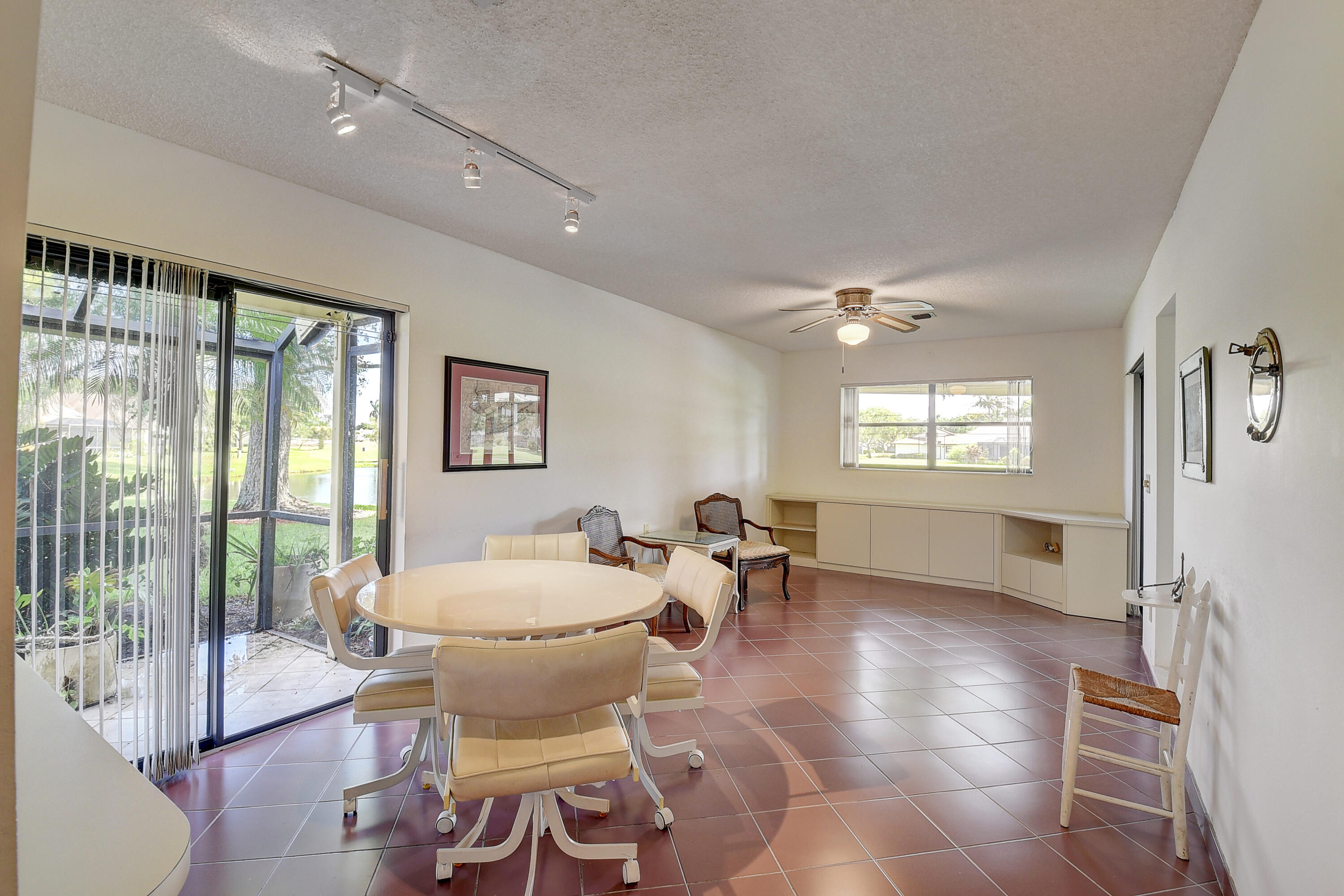 5642 Forest Oaks Terrace Delray Beach, FL 33484 - Photo 7 of 37 a living room with furniture a large window and wooden floor