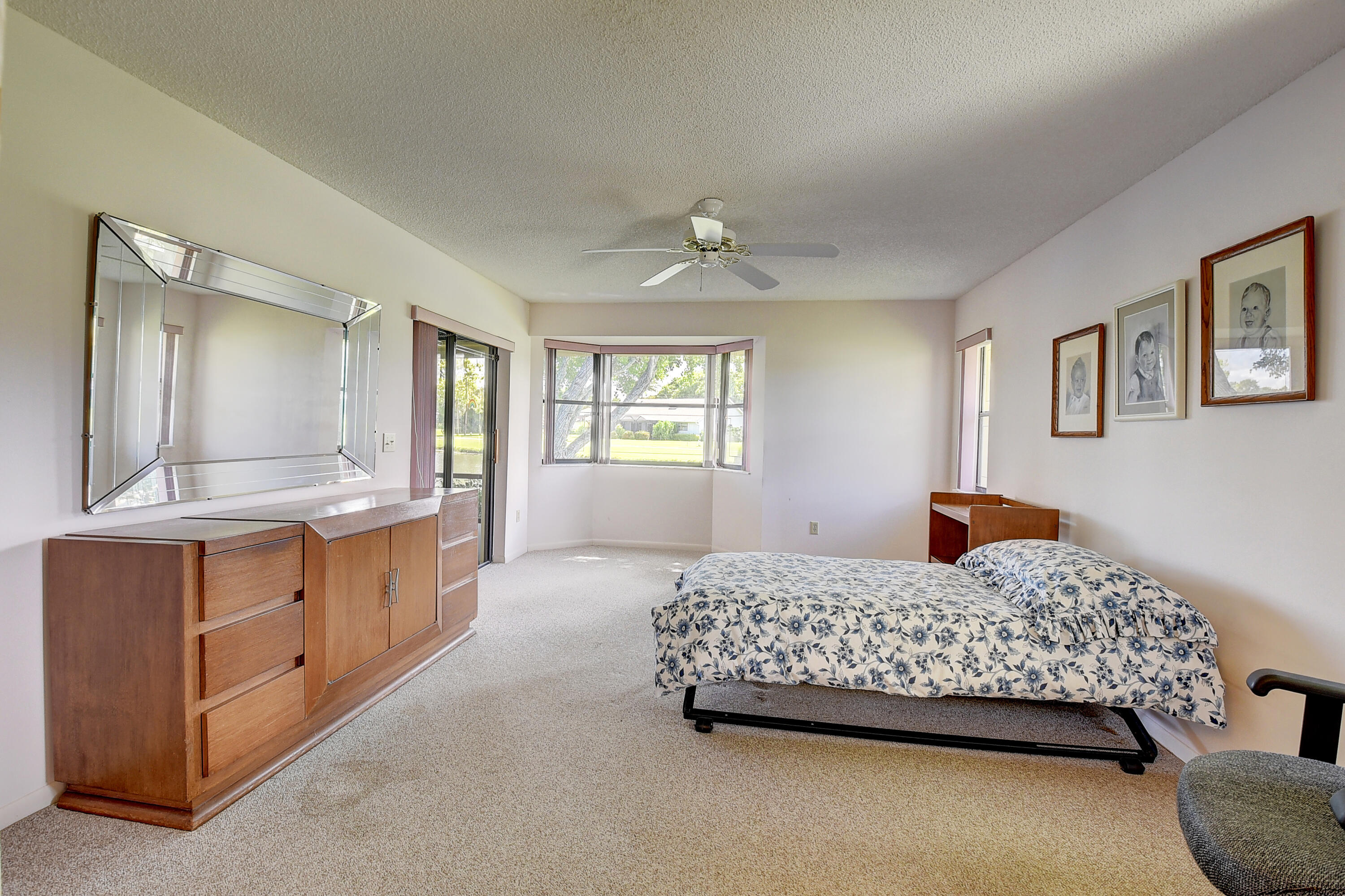 5642 Forest Oaks Terrace Delray Beach, FL 33484 - Photo 8 of 37 a bedroom with a bed and a dresser