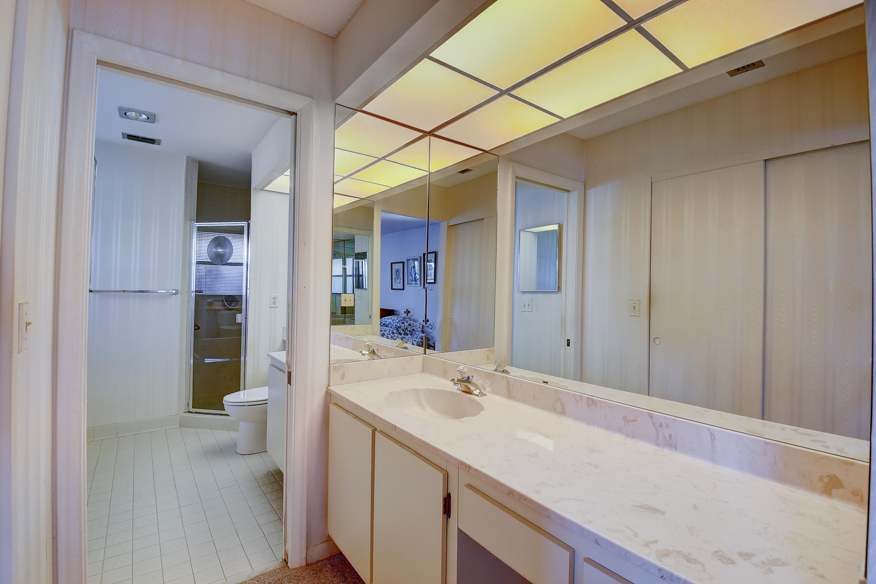 5642 Forest Oaks Terrace Delray Beach, FL 33484 - Photo 10 of 37 a bathroom with a sink and a mirror