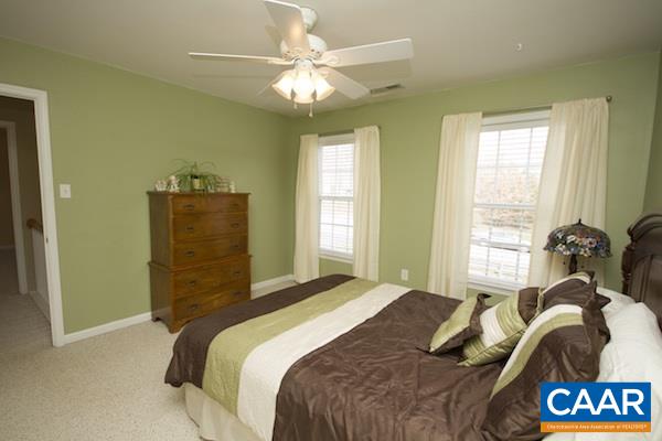 330 Northridge Road Ruckersville, VA 22968 - Photo 12 of 36 a bedroom with a bed and a chandelier