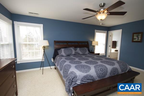 330 Northridge Road Ruckersville, VA 22968 - Photo 4 of 36 a bedroom with a large bed and a chandelier