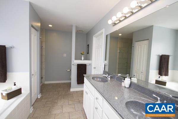 330 Northridge Road Ruckersville, VA 22968 - Photo 7 of 36 a bathroom with a granite countertop sink a mirror and a shower
