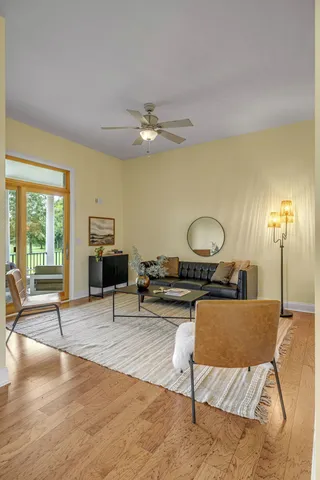 a living room with furniture and a wooden floor