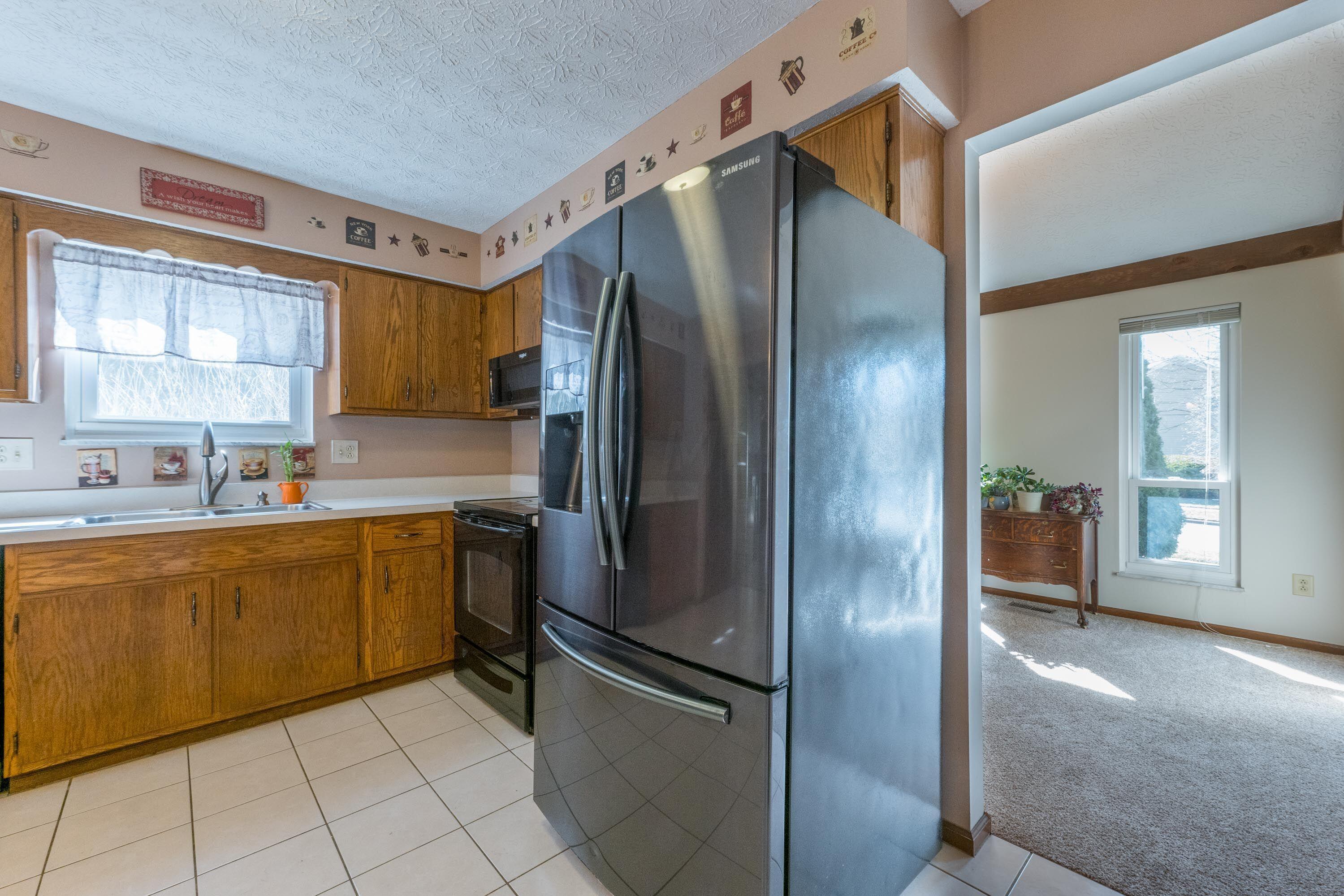 7826 Strathmoore Road Dublin, OH 43016 - Photo 10 of 47 Newer Stainless Steel Refrigerator to the Dining Room.