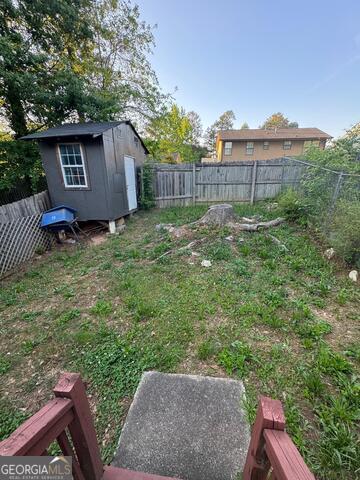 6444 Charter Way Lithonia, GA 30058 - Photo 17 of 18 a view of a backyard with a tub and wooden fence