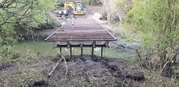a wooden bench sitting in middle of forest