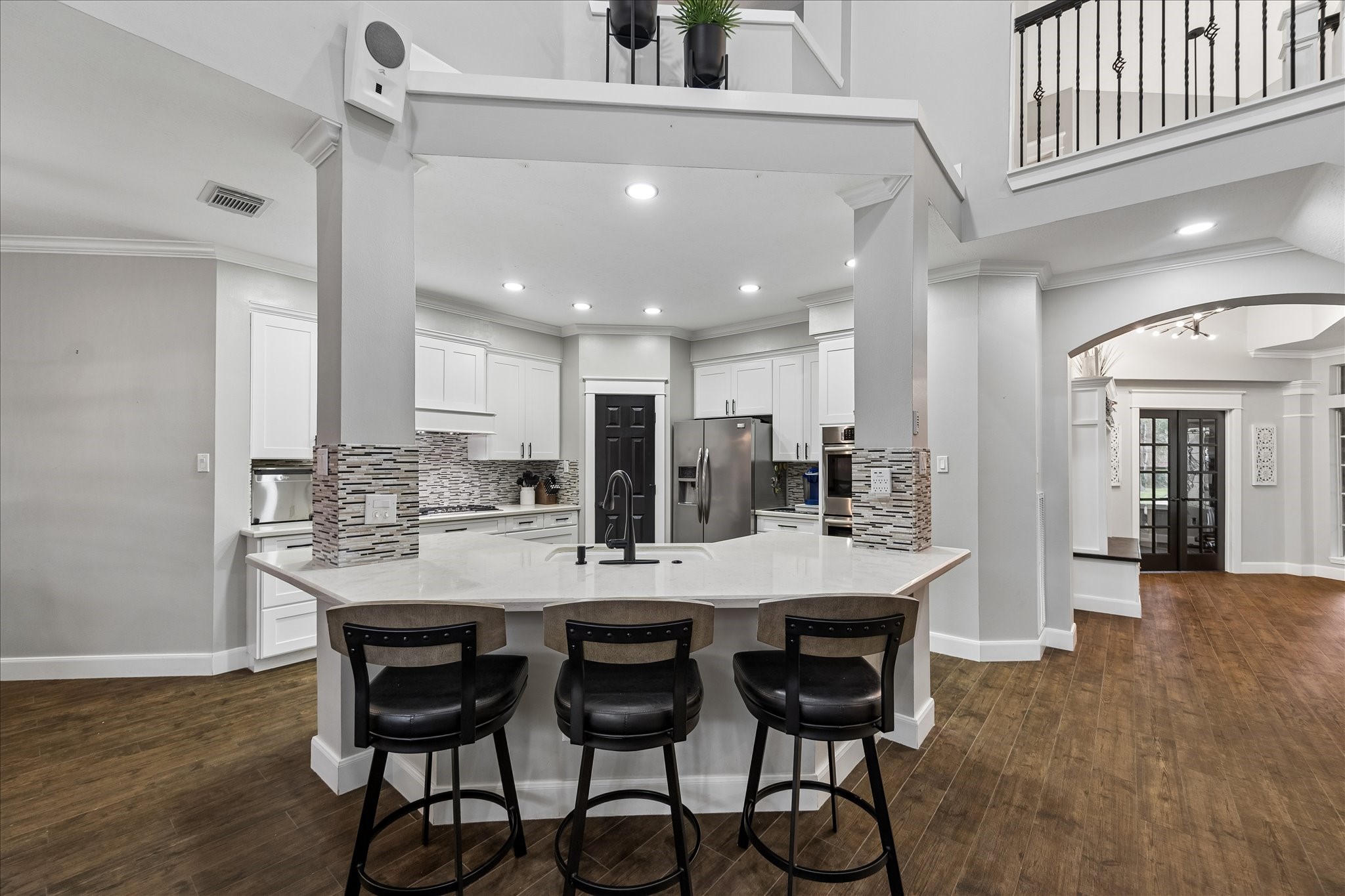 23039 Enchanted Landing Lane Katy, TX 77494 - Photo 12 of 30 a kitchen with a dining table chairs cabinets and stainless steel appliances