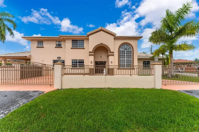 a front view of a house with a garden and yard