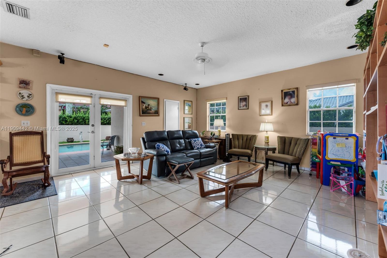 3200 Southwest 132nd Avenue Miami, FL 33175 - Photo 16 of 55 a living room with furniture a flat screen tv and a window