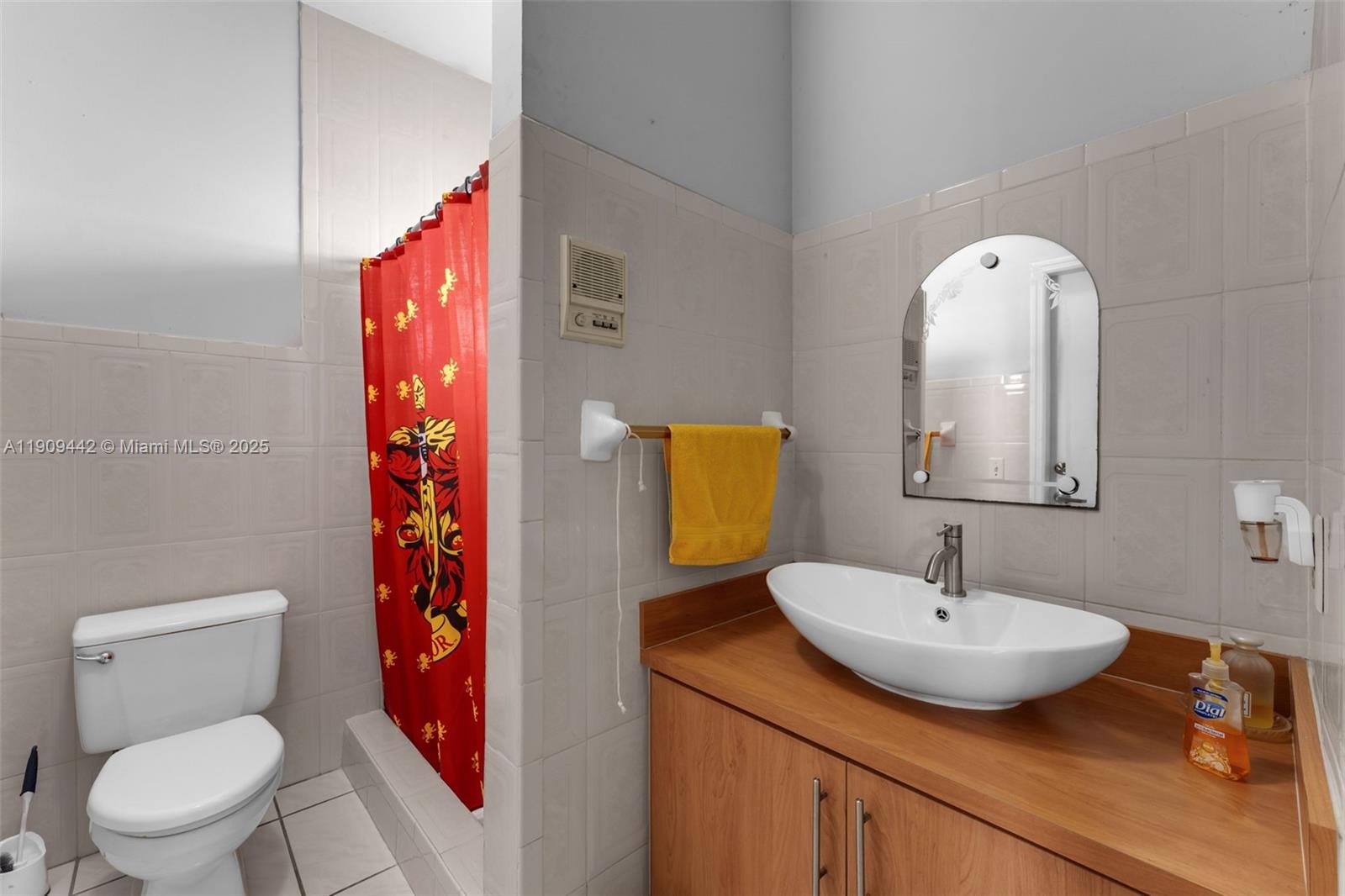 3200 Southwest 132nd Avenue Miami, FL 33175 - Photo 17 of 55 a bathroom with a toilet sink and mirror