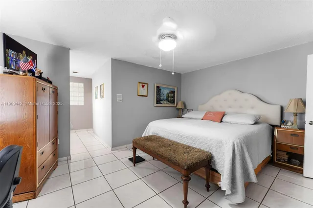 a bedroom with a bed and a view of hallway