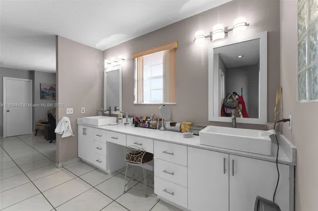 a bathroom with a sink a vanity and a mirror