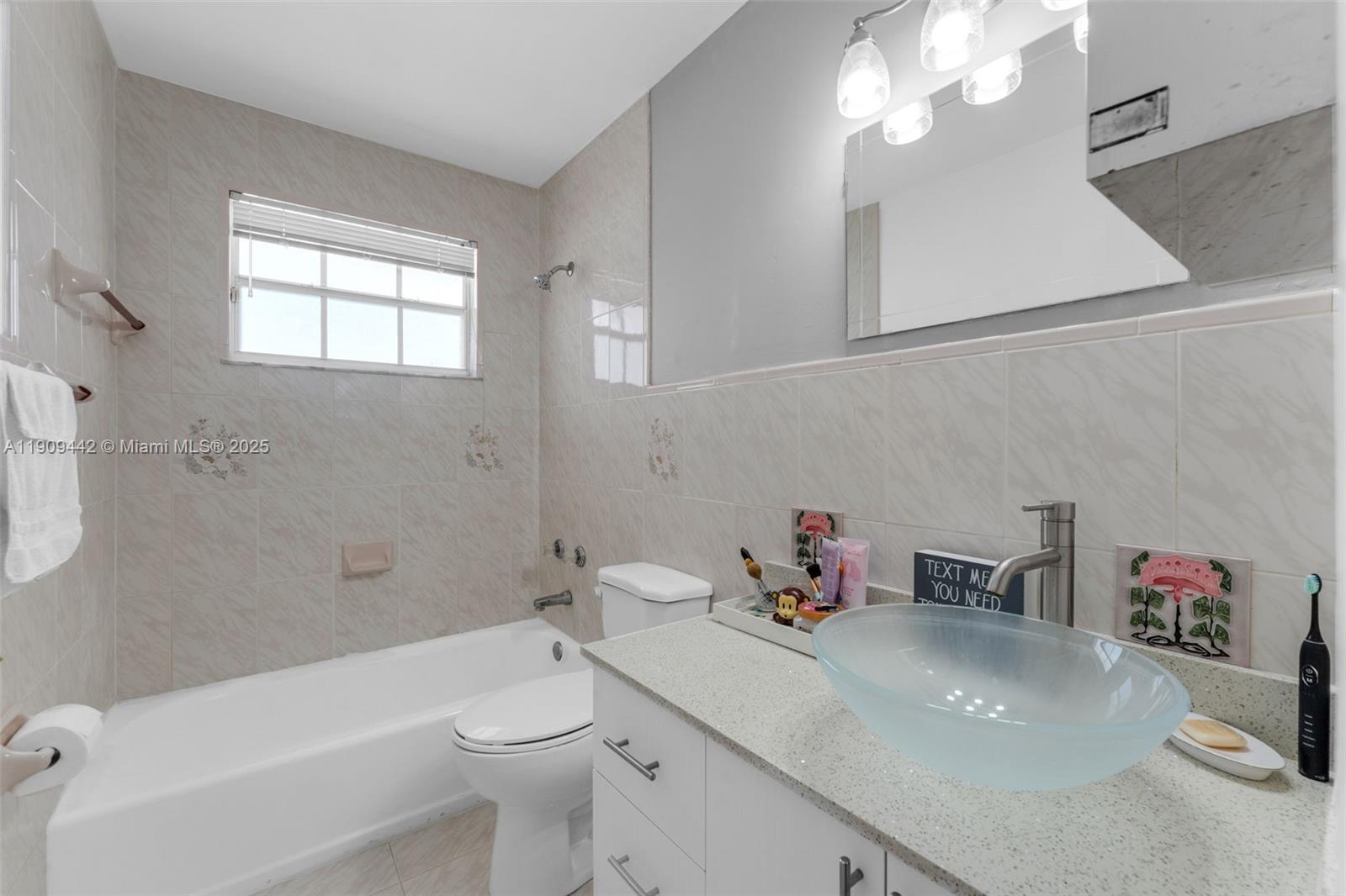 3200 Southwest 132nd Avenue Miami, FL 33175 - Photo 31 of 55 a bathroom with a sink a toilet and a bathtub