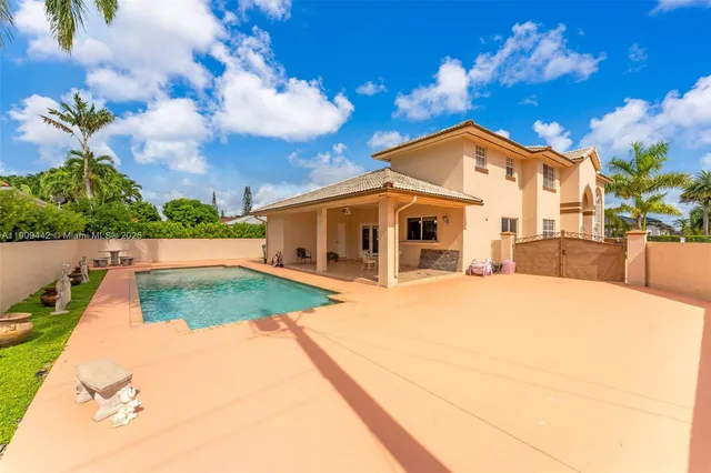 a living room with furniture a window and a flat screen tv