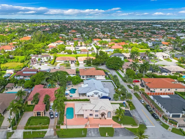 an aerial view of residential houses with outdoor space and street view