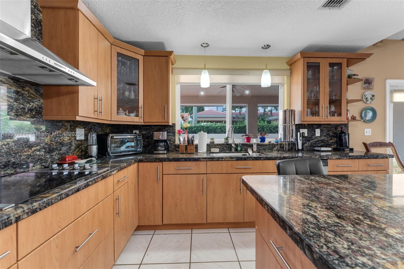 3200 Southwest 132nd Avenue Miami, FL 33175 - Photo 8 of 55 a kitchen with stainless steel appliances granite countertop a sink and cabinets
