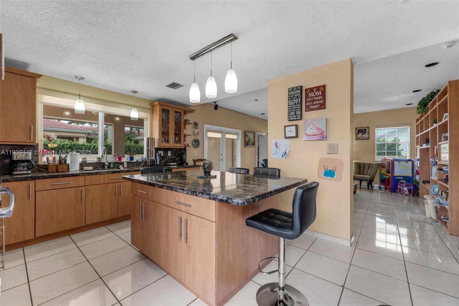 3200 Southwest 132nd Avenue Miami, FL 33175 - Photo 9 of 55 a kitchen with stainless steel appliances granite countertop a sink and cabinets