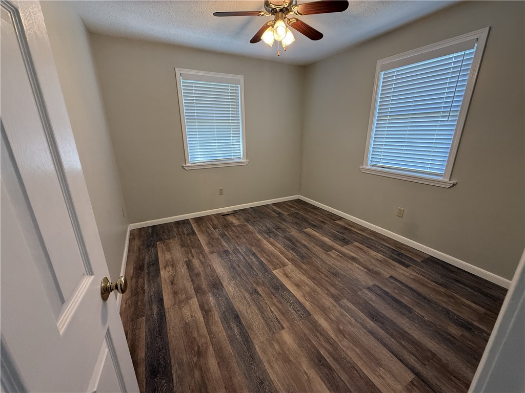 238 State Rd S-37-435 Westminster, SC 29693 - Photo 4 of 9 A quiet bedroom featuring elegant wood-look flooring and a classic ceiling fan for ultimate comfort.