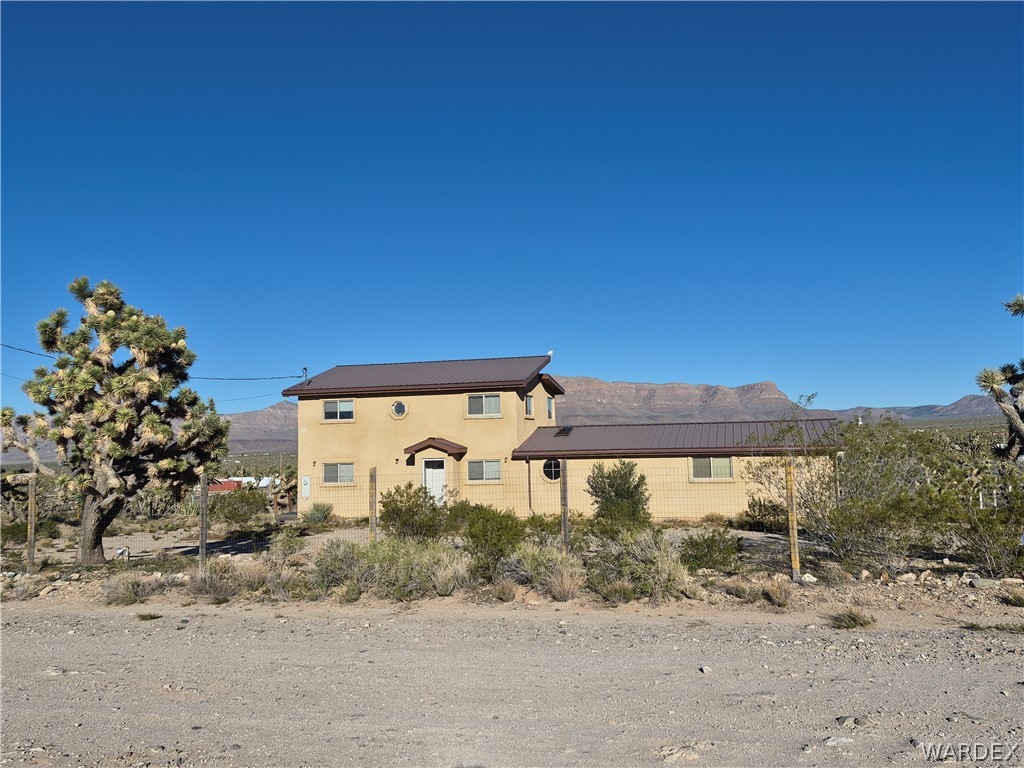 26432 Tamarisk Street, Unit STREET Meadview, AZ 86444 - Photo 1 of 60 View of front of property with a view of the Grand Wash Cliffs and a metal roof