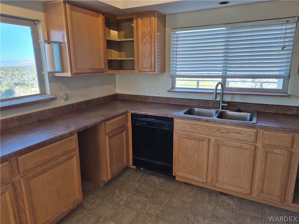 26432 Tamarisk Street, Unit STREET Meadview, AZ 86444 - Photo 15 of 60 Kitchen featuring dark countertops, dishwasher, and open shelves