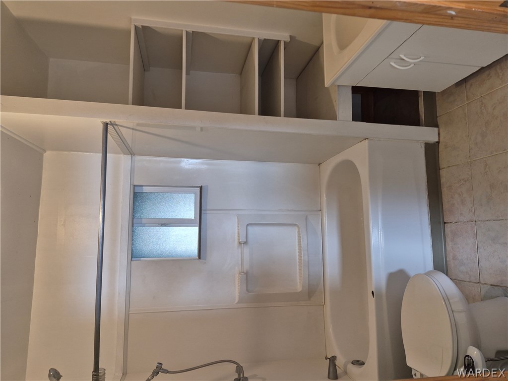26432 Tamarisk Street, Unit STREET Meadview, AZ 86444 - Photo 28 of 60 Upstairs Full bathroom with vanity, washtub / shower combination, and light tile patterned floors