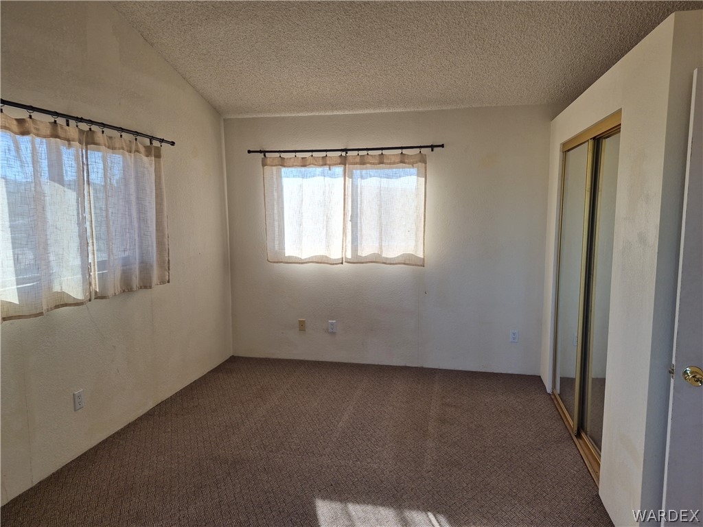 26432 Tamarisk Street, Unit STREET Meadview, AZ 86444 - Photo 30 of 60 Unfurnished bedroom with carpet floors and a closet