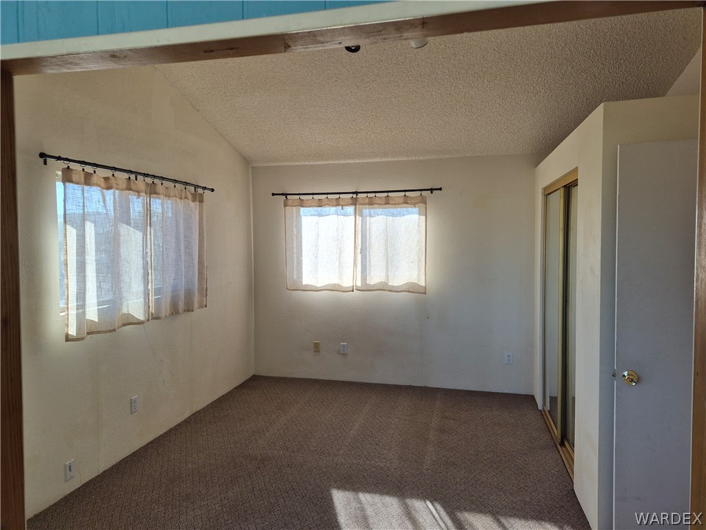 26432 Tamarisk Street, Unit STREET Meadview, AZ 86444 - Photo 34 of 60 Unfurnished bedroom featuring carpet flooring and a closet