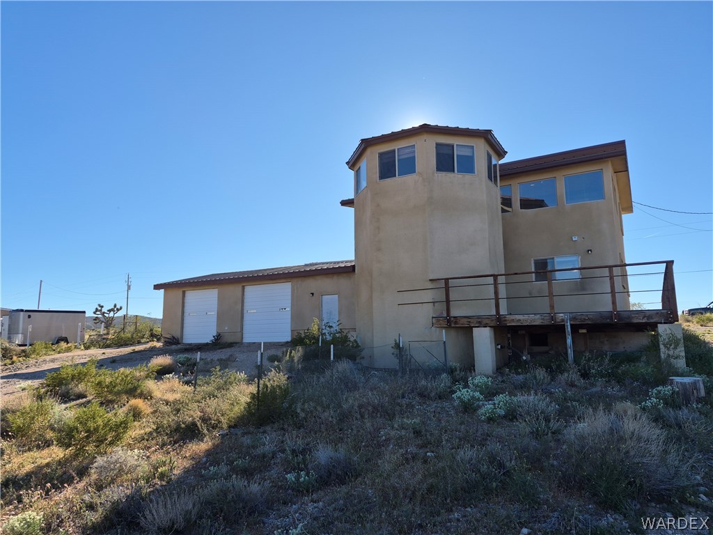 26432 Tamarisk Street, Unit STREET Meadview, AZ 86444 - Photo 40 of 60 Back of property with a garage, stucco siding, and a deck