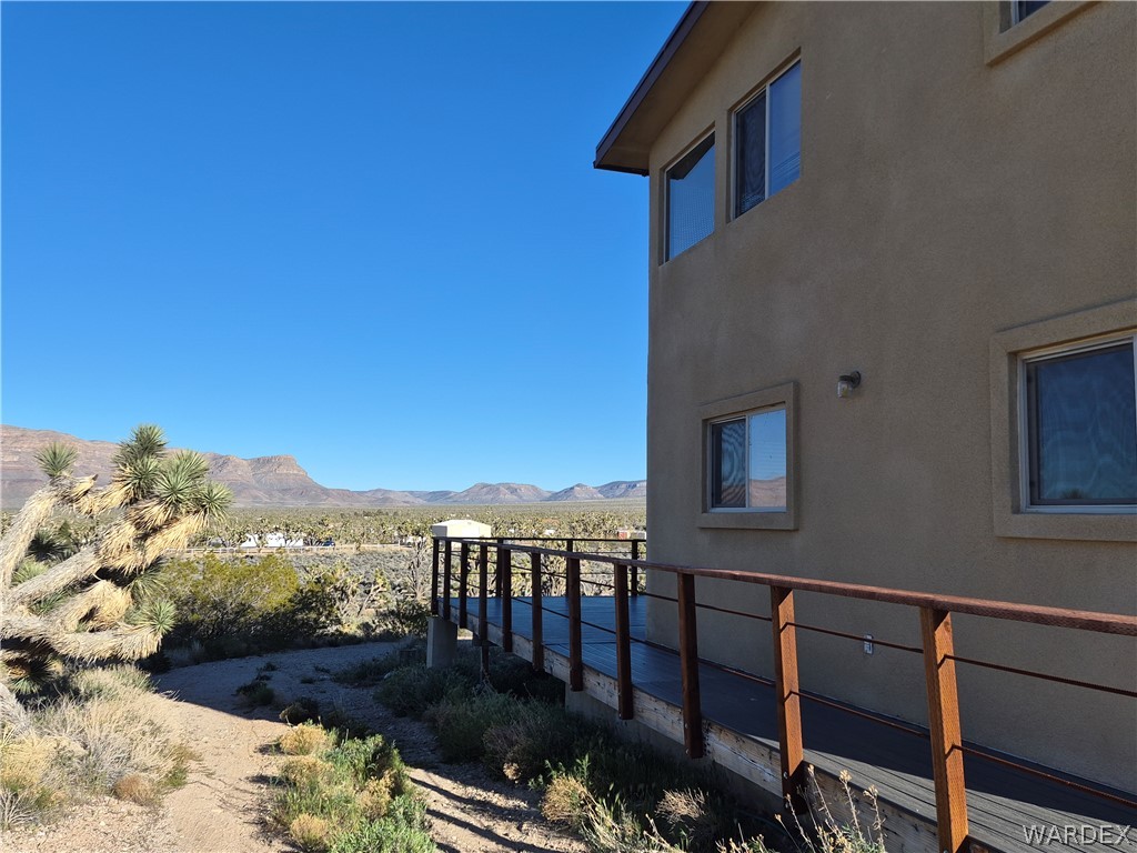 26432 Tamarisk Street, Unit STREET Meadview, AZ 86444 - Photo 43 of 60 View of side of home with stucco siding and a mountain view