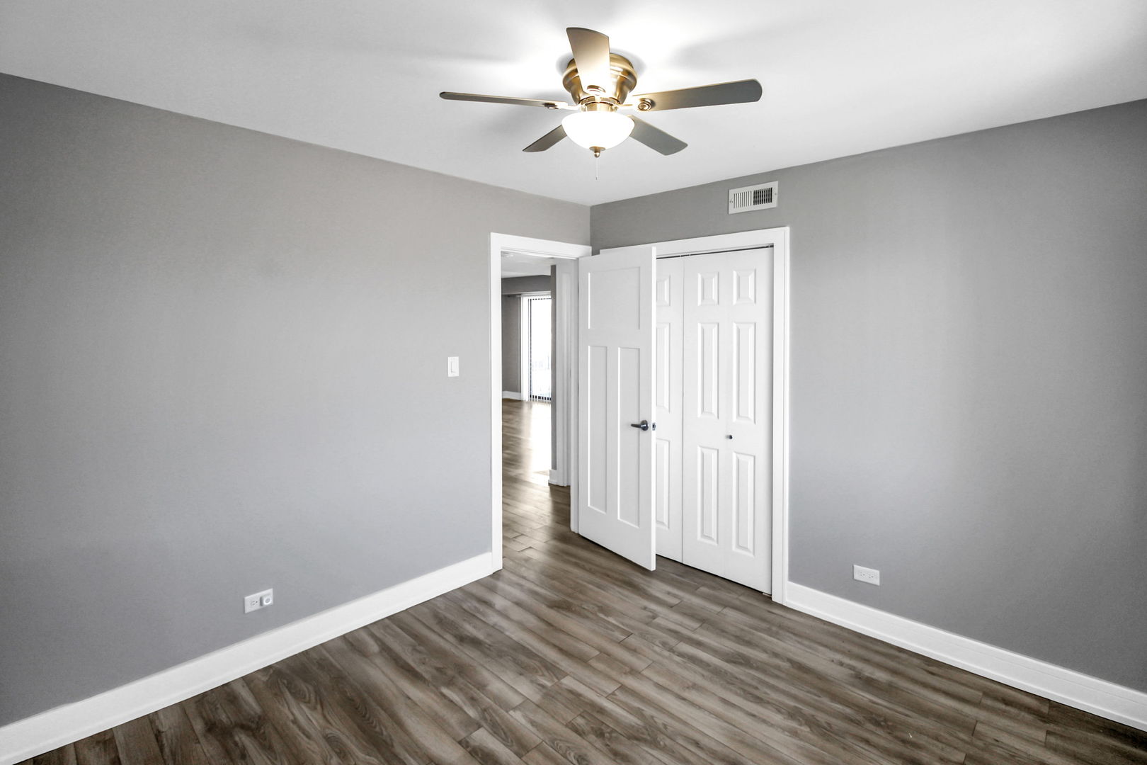 16622 Theresa Lane, Unit 304 Tinley Park, IL 60477 - Photo 13 of 16 wooden floor in an empty room with a window