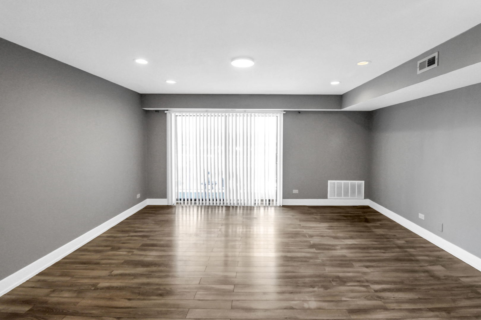 16622 Theresa Lane, Unit 304 Tinley Park, IL 60477 - Photo 2 of 16 a view of an empty room with wooden floor and a window