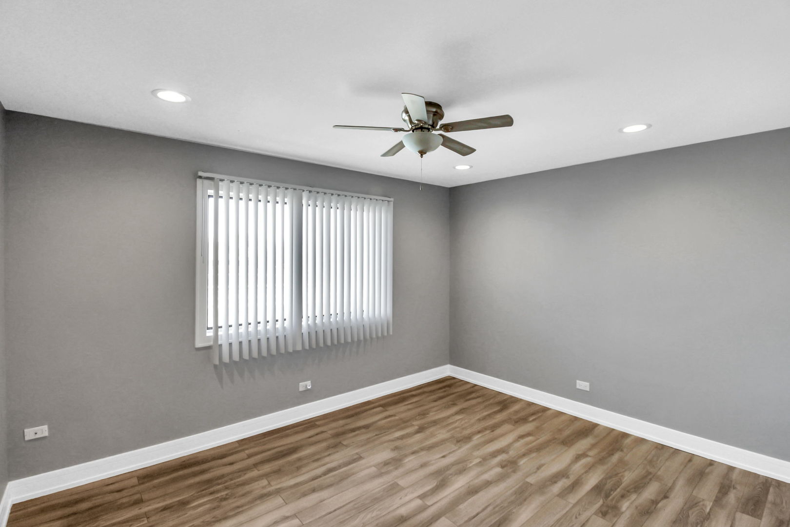 16622 Theresa Lane, Unit 304 Tinley Park, IL 60477 - Photo 4 of 16 a view of empty room with wooden floor and fan