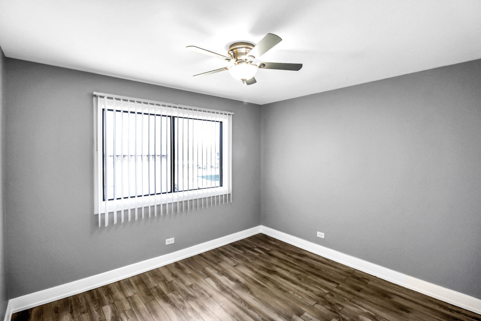16622 Theresa Lane, Unit 304 Tinley Park, IL 60477 - Photo 5 of 16 a view of a room with wooden floor and fan